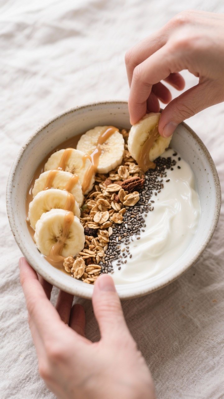 Cooking process: Peanut Butter Banana Yogurt Bowl being assembled—yogurt base already mixed with v
