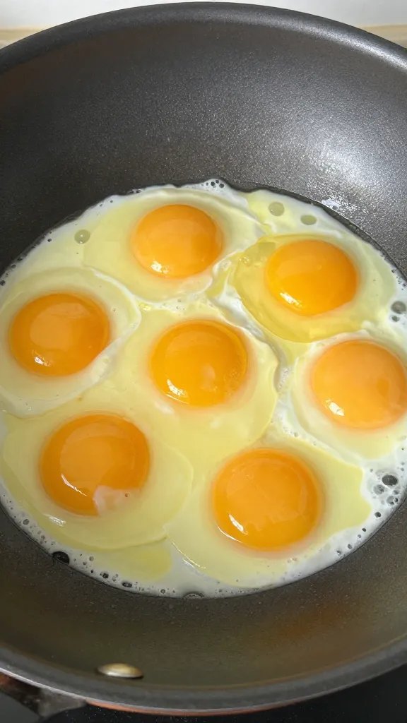 silky custardy eggs in wok, tight shot